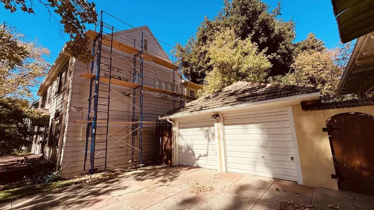 Frame scaffold from Kireon on a two-story home exterior next to a garage in the Sacramento area