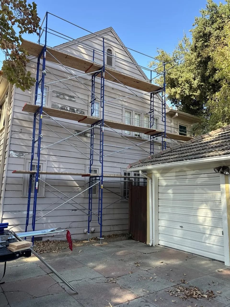 Frame scaffold from Kireon with planks on three levels along a two-story home exterior in the Sacramento area