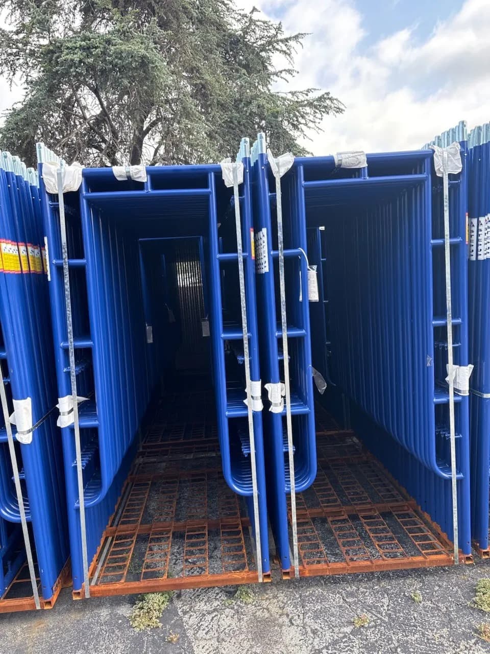 Bundles of new blue scaffold frames in Kireon stock